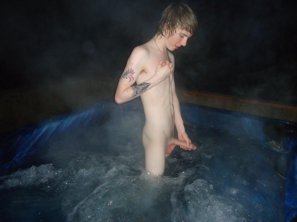 Slim teen boy nude in an outdoor jacuzzi